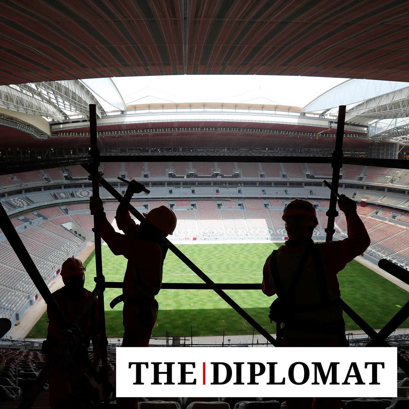 Laborers remove scaffolding at the Al Bayt stadium in Al Khor, Qatar, about 50 kilometers (30 miles) north of Doha, Monday, April 29, 2019.