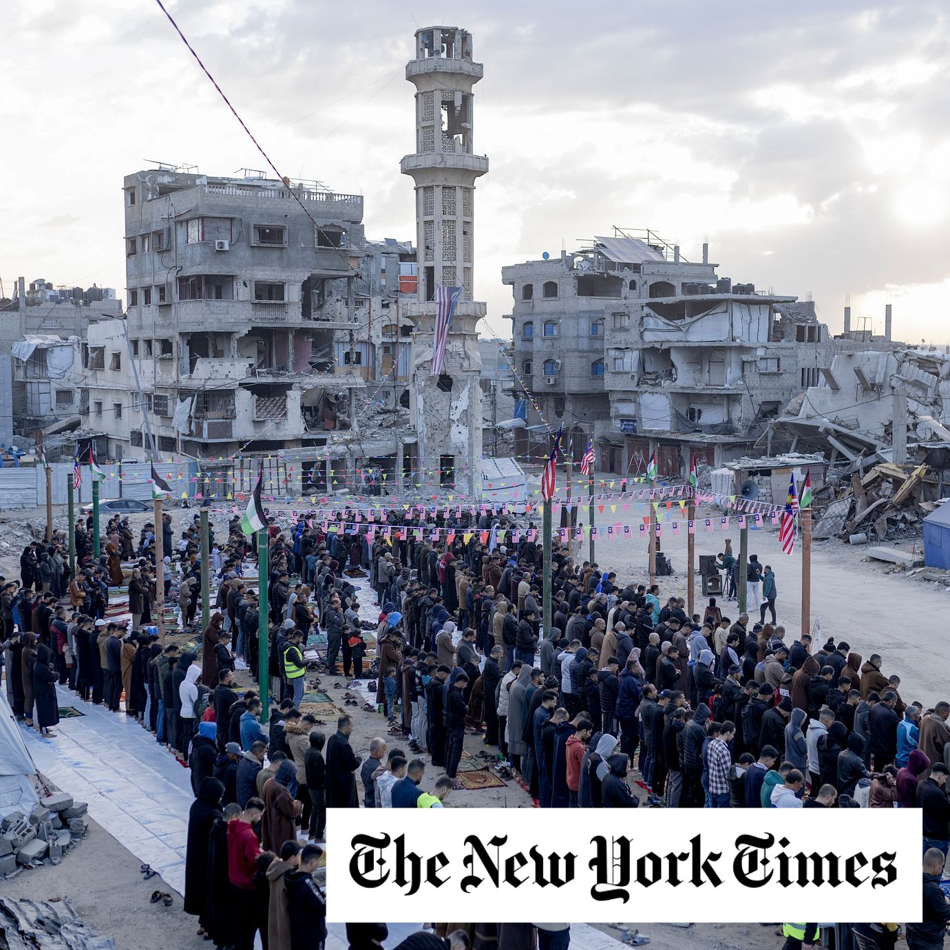 People perform a prayer for Eid al-Fitr alongside the ruins of the destroyed al-Yarmouk Mosque in central Gaza City.