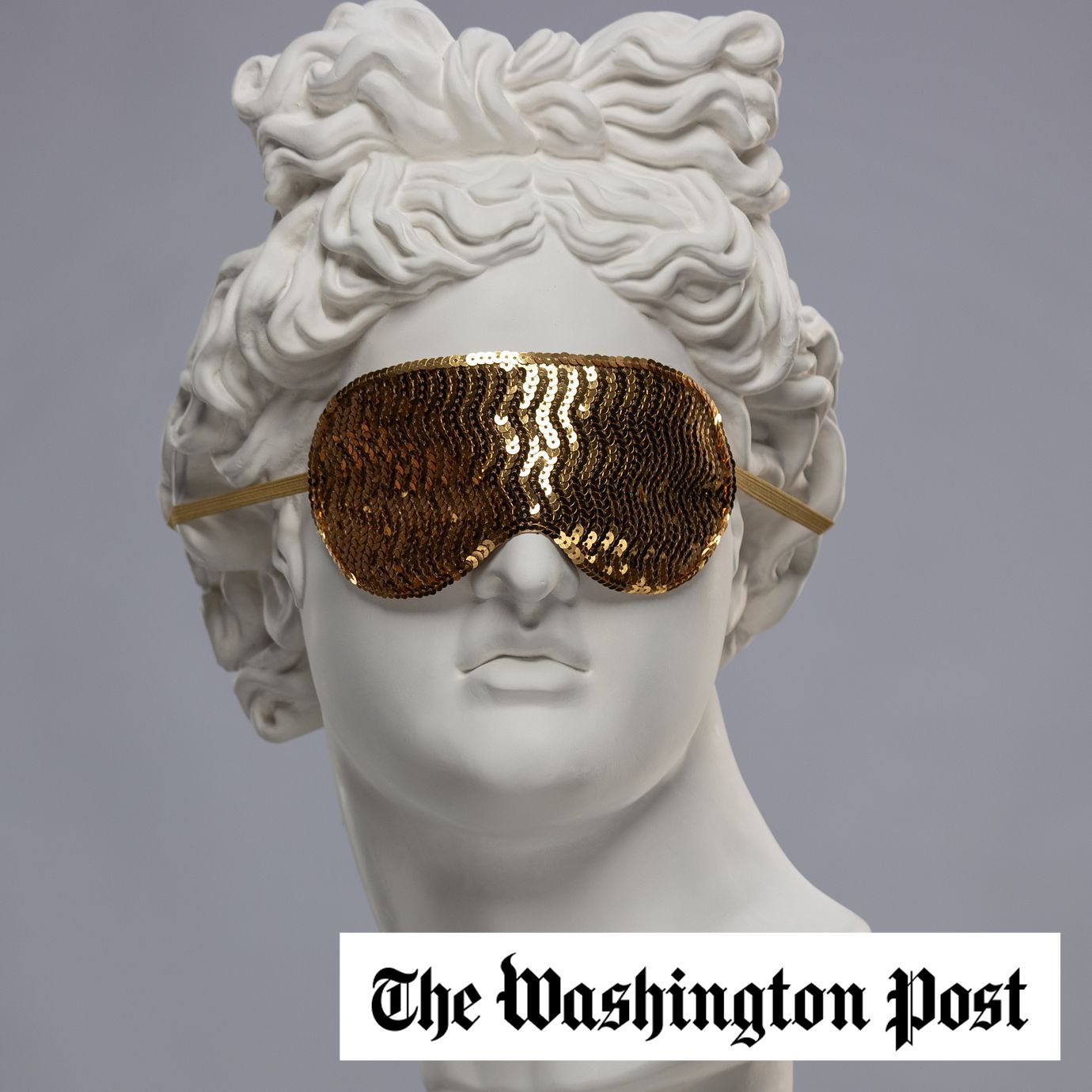 Statue of a bust of Apollo's head in a golden sleep mask covering his face
