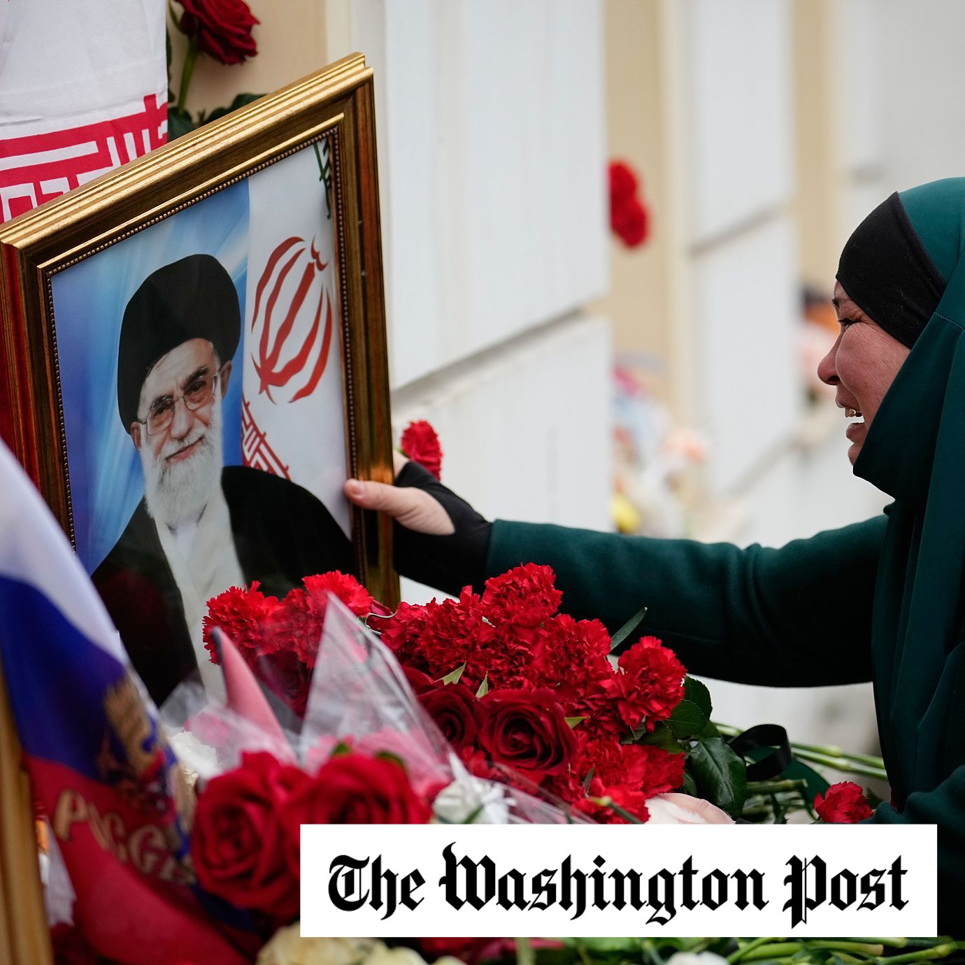 A Tajik woman cries while touching a portrait of killed Iran’s Supreme Leader Ayatollah Ali Khamenei at the Iranian Embassy in Moscow.
