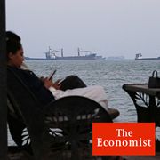 A cafe overlooking commercial vessels anchored in the Strait of Hormuz, off Bandar Abbas, Iran.