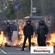 Demonstrators in front of a burning barricade in Belfast on June 9.
