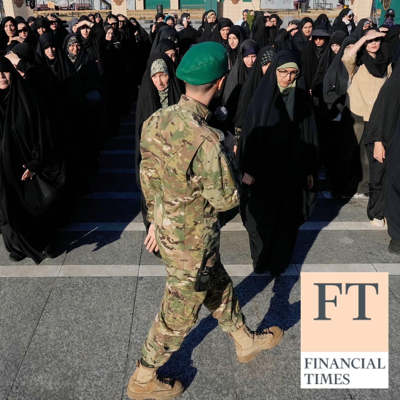 A member of the military affiliated with Iran’s Revolutionary Guard organizes volunteers as they attend a military training course at a camp set up in Imam Hussein Square in Tehran.