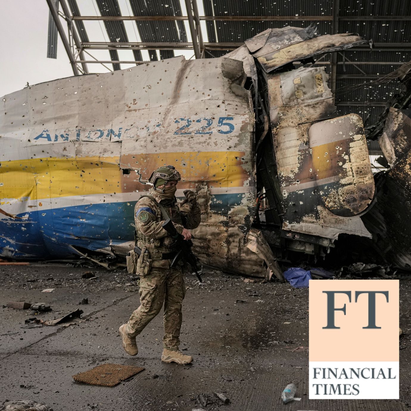 A Ukrainian serviceman walks by the front section of the Antonov An-225 Mriya aircraft destroyed during fighting between Russian and Ukrainian forces at the Antonov airport in Hostomel, Ukraine