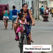 A woman and a girl ride a bicycle in Havana, Cuba, May 8.