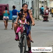 A woman and a girl ride a bicycle in Havana, Cuba, May 8.