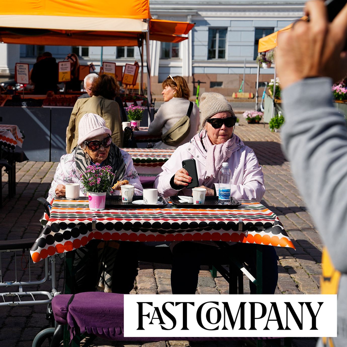Women sit in a street food market in Helsinki, Finland.