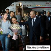 Russian President Vladimir Putin, foreground right, walks with released Russian prisoners and relatives upon their arrival at the Vnukovo government airport outside Moscow, Russia, on Thursday, Aug. 1, 2024.
