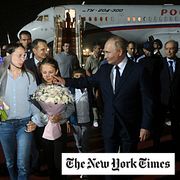 Russian President Vladimir Putin, foreground right, walks with released Russian prisoners and relatives upon their arrival at the Vnukovo government airport outside Moscow, Russia, on Thursday, Aug. 1, 2024.