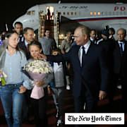 Russian President Vladimir Putin, foreground right, walks with released Russian prisoners and relatives upon their arrival at the Vnukovo government airport outside Moscow, Russia, on Thursday, Aug. 1, 2024.