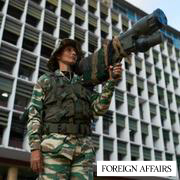 A Bolivarian militia member holds a weapon at a government-organized rally against foreign interference, in Caracas, Venezuela, Thursday, Oct. 30, 2025.