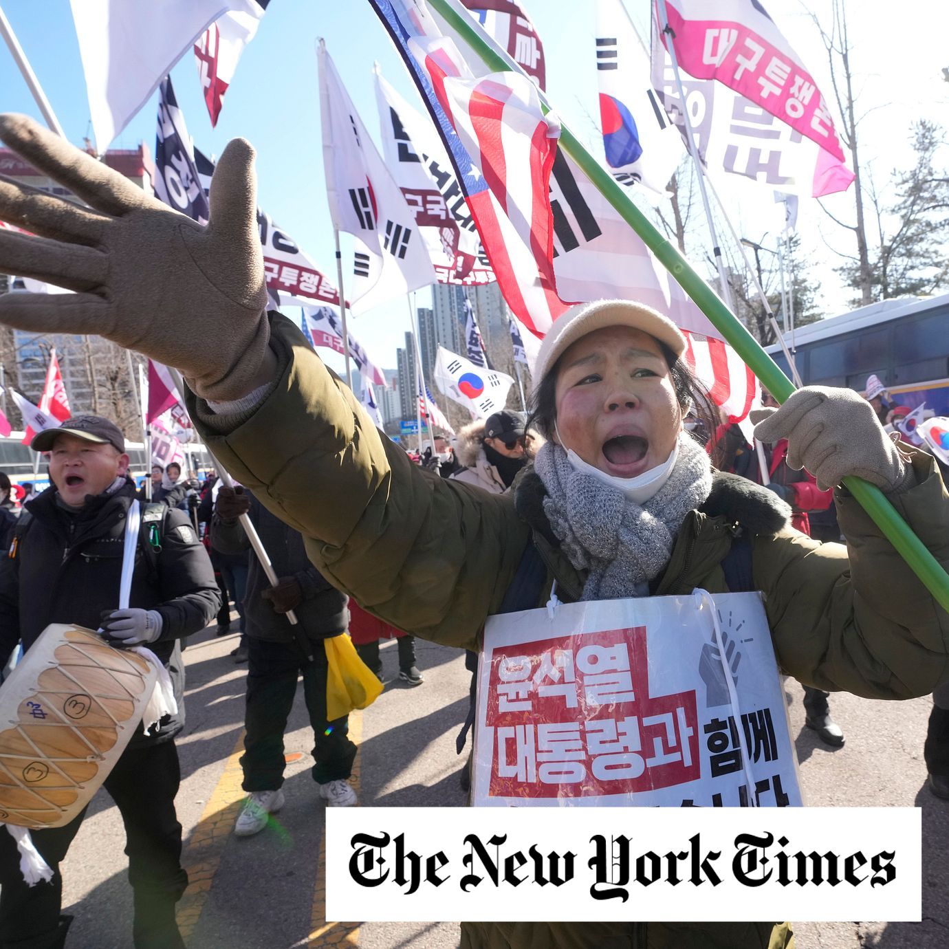 A supporter of impeached South Korean President Yoon Suk Yeol shouts slogans during a rally to oppose his impeachment, in Gwacheon, South Korea, Wednesday, Jan. 15, 2025. The letters read, "We will fight together with President Yoon Suk Yeol."