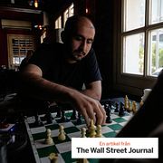 Men play chess as they spend an afternoon at a cafe in downtown Tehran, Iran, in August.