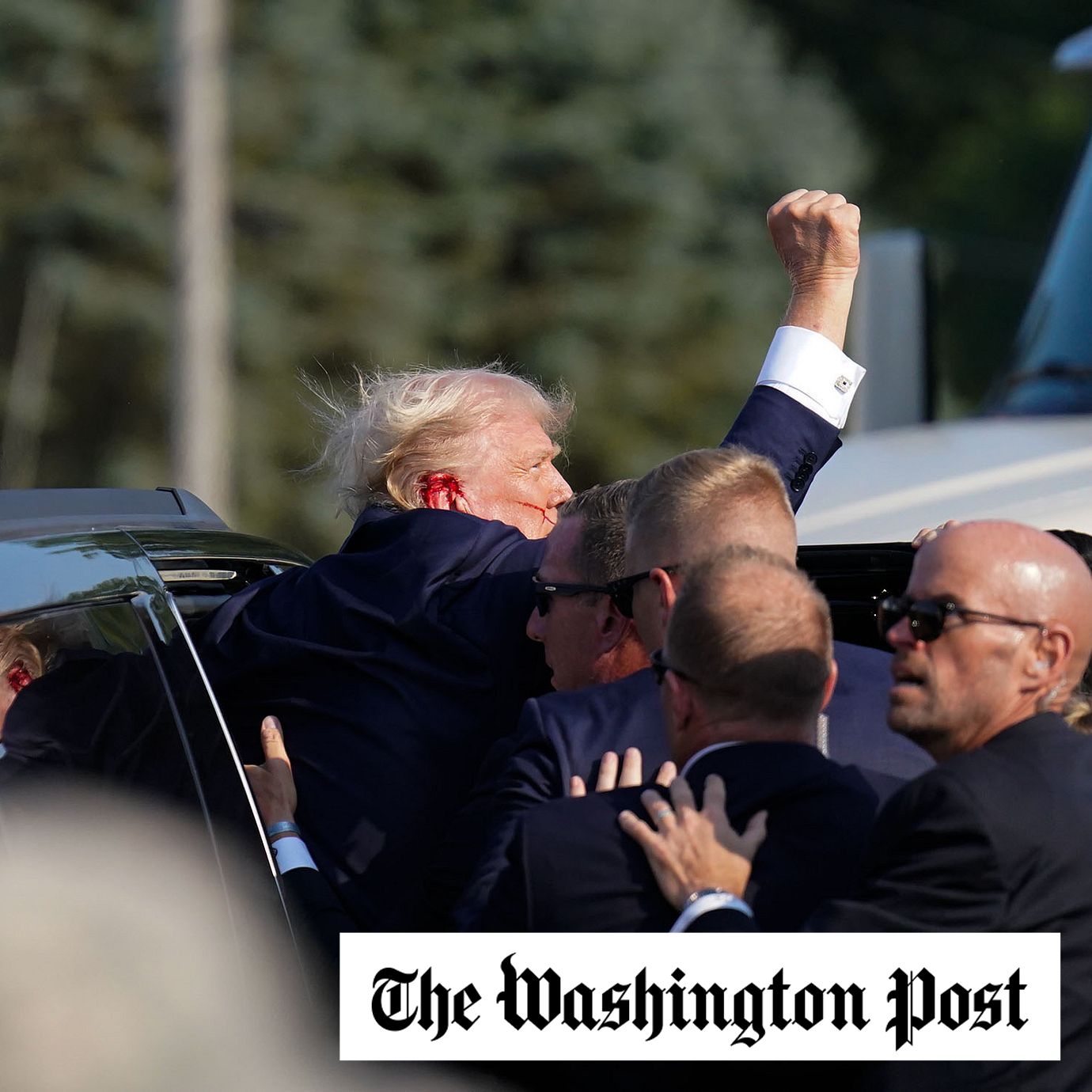 Members of the Secret Service help former president Donald Trump into a vehicle after shots rang during his rally in Butler, Pa., on Saturday. MUST CREDIT: Jabin Botsford/The Washington Post