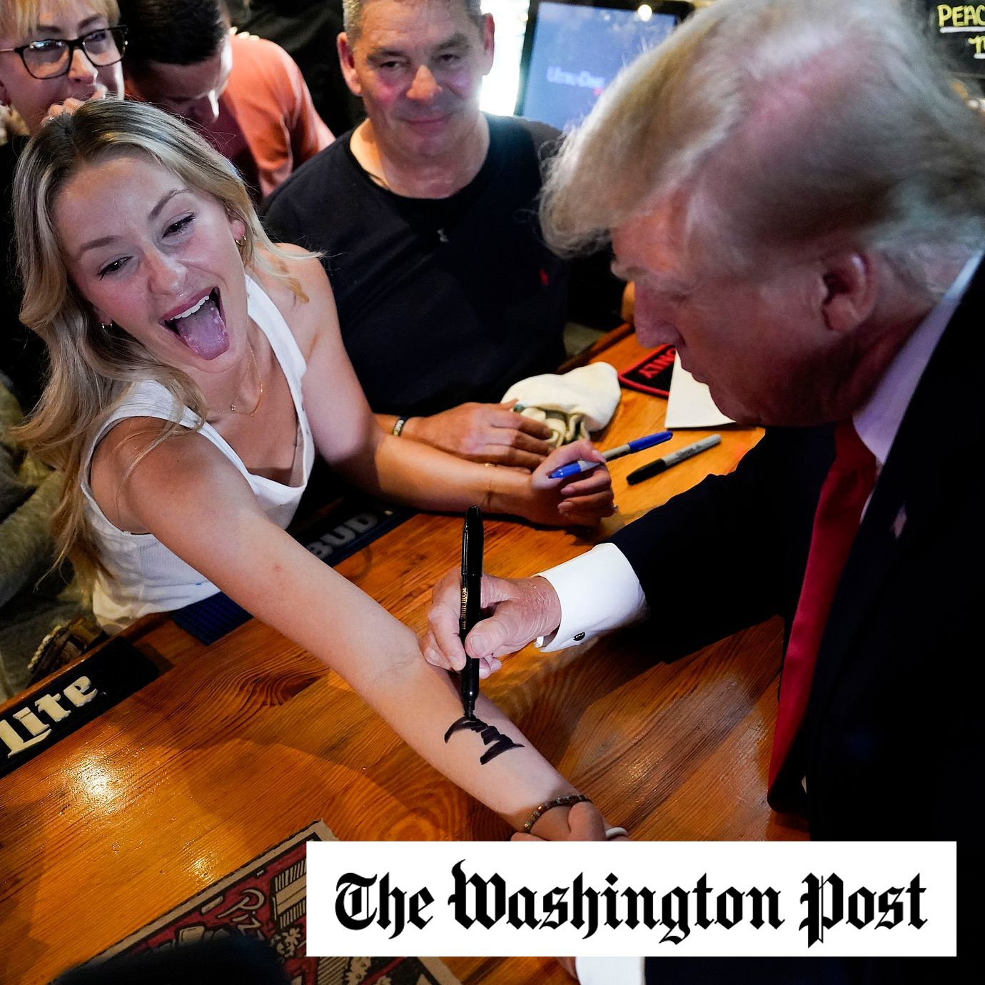 A supporter at a restaurant in Bettendorf, Iowa, gets a Trump autograph in September.
