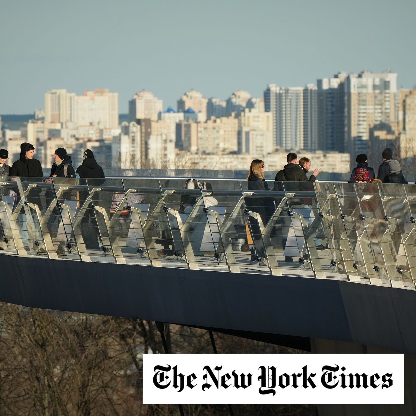 People walk on the bridge during sunset in Kyiv, Ukraine, Monday, March 2, 2026.