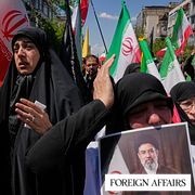 A woman holds a picture depicting Iran's Supreme Leader Mojtaba Khamenei, top, and his father, the slain Supreme Leader Ayatollah Ali Khamenei, as government supporters gather to mark the 40th day since his death in Tehran.