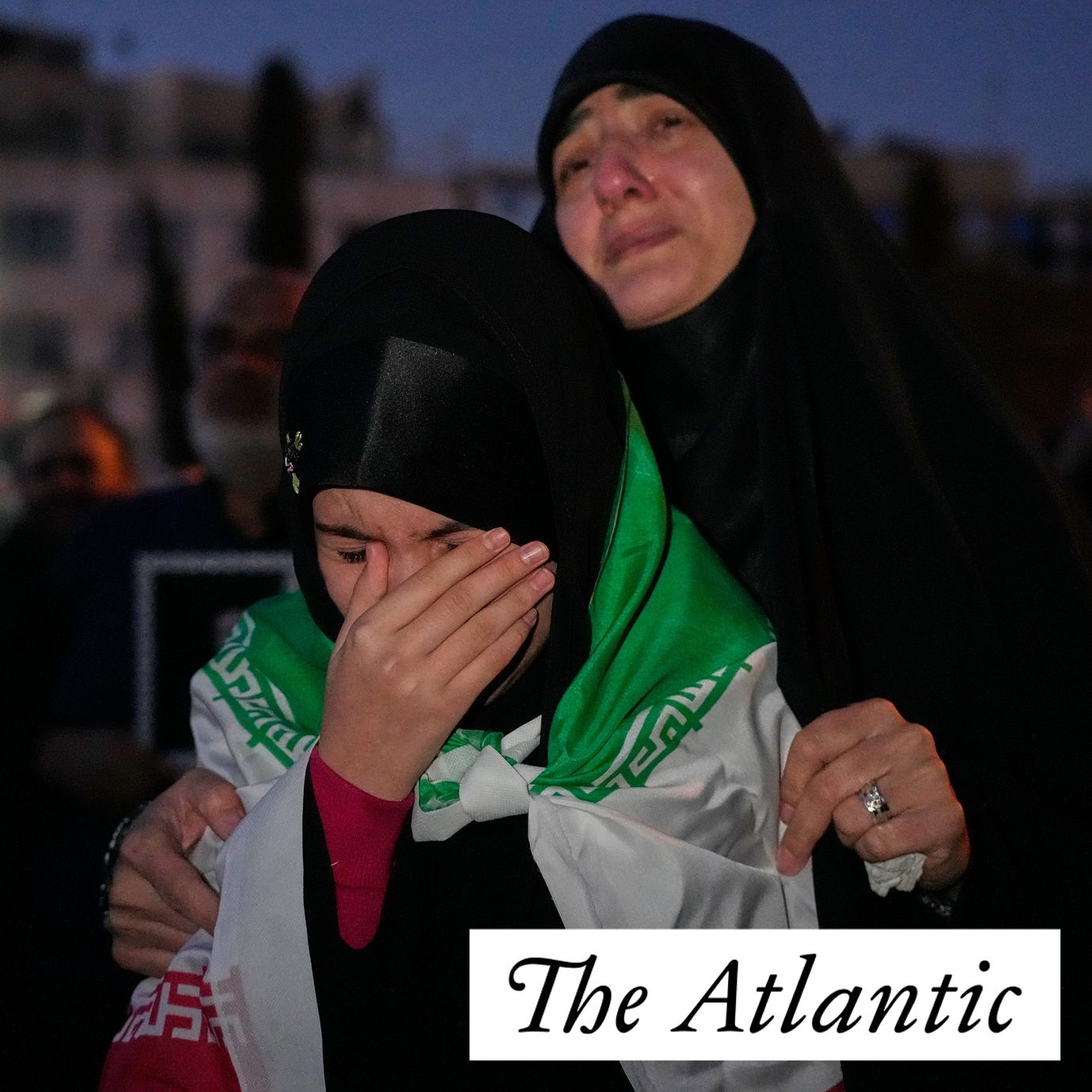 Government supporters mourn in a gathering after state TV officially announced the death of Iranian Supreme Leader Ayatollah Ali Khamenei, as one of them wears an Iranian flag, in Tehran, Iran, Sunday, March 1, 2026.