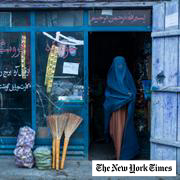 An Afghan woman wearing a burka exits a small shop in Kabul, Afghanistan, Sunday, Dec. 5, 2021.