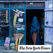An Afghan woman wearing a burka exits a small shop in Kabul, Afghanistan, Sunday, Dec. 5, 2021.