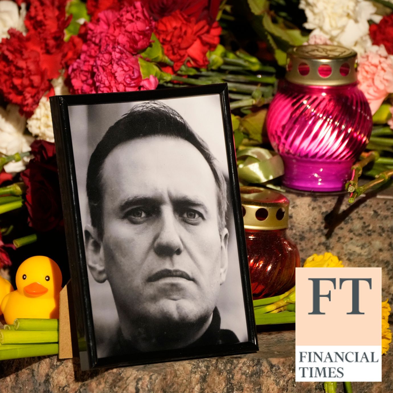 A portrait of Russian opposition leader Alexei Navalny, flowers and candles are laid on a ground as people gather to pay their last respect to Alexei Navalny at the Memorial to Victims of Political Repression in St. Petersburg, Russia on Friday, Feb. 16, 2024.