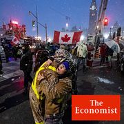 Protesters dance and embrace as a song plays over the speakers, during an ongoing protest against COVID-19 measures that has grown into a broader anti-government protest, in Ottawa, Ontario, on Thursday, Feb. 17, 2022.